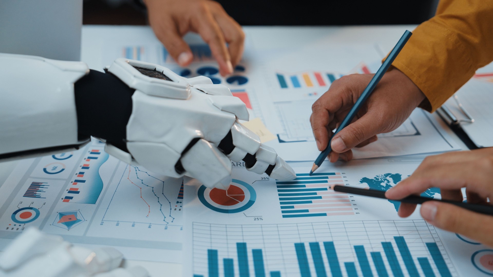 Human Hand and Robotic Hand Collaborating on Data Analysis with Charts, Graphs, and Business Reports in Modern Office Setting. Noogenesis